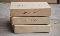 a stack of cardboard boxes sitting on top of a cement floor