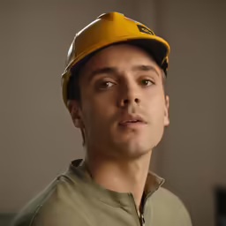 there is a man wearing a yellow hat