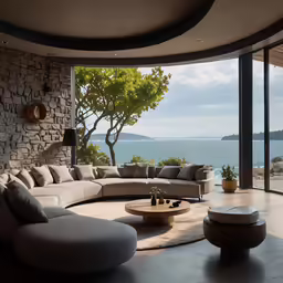 an elegant living room overlooks the ocean and trees