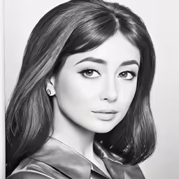 a black and white photo of a girl in a tie