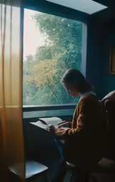 a woman reading a book on a porch