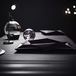 a black table has silver plates and glass ball