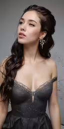 an asian woman posing in a grey dress