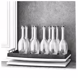 four bottles on a shelf near some books