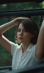 a beautiful woman sitting in the passenger seat of a car