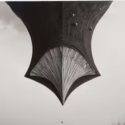 a black and white photo shows an open umbrella