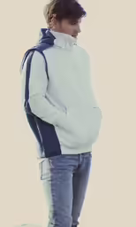a man in jeans standing with his hand on his hip