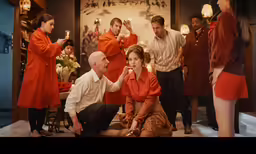 a man is kneeling in front of other people