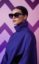 a woman is wearing sunglasses and standing in front of a background