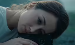 a woman taking a photograph with a camera