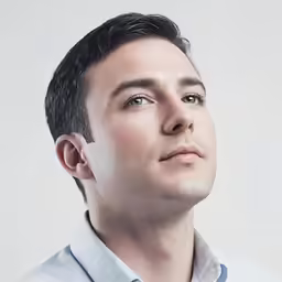a man with a tie on is posing for a picture