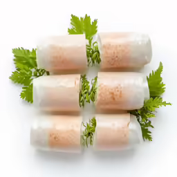 four rolled up rolls on top of each other with a bunch of parsley sprigs