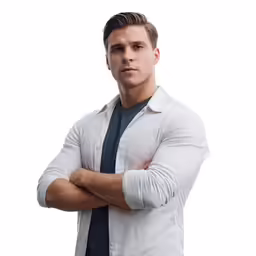 man in white shirt and tie standing with his arms folded