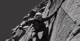 a man climbing up the side of a cliff