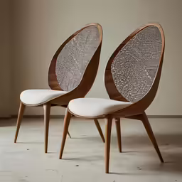 two wooden chairs with wicker seats are sitting side by side