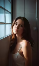 a woman looking out the window while leaning on the ledge