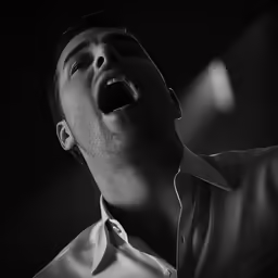 a man looking up and screaming in the air