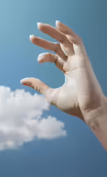 an adult hand with white nails and short fingernails