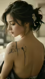 a woman has her back tattoo painted black