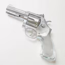 an old silver revolver with clear grips on white background