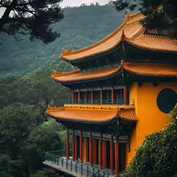 a tall pagoda with orange painted roof on top of a mountain