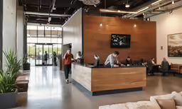 a lobby with people, and a person walking by