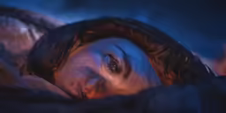 a man that is laying down on a bed