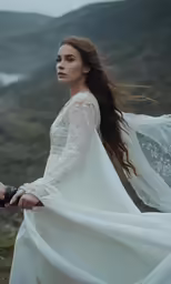 a beautiful woman with long hair in a wedding dress