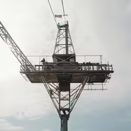 a crane is being lowered over the ocean