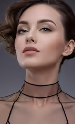 a woman wearing a neck chain and choker