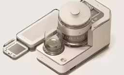 a digital blender and cell phone are sitting together