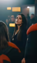 a beautiful young woman standing in front of a crowd