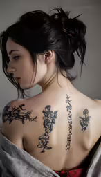 a very pretty woman with a very tattoed back