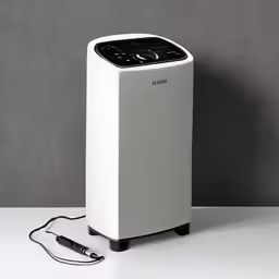 this air purifitor is sitting on a table next to wires
