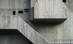 some very tall concrete buildings with some windows