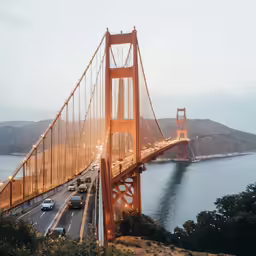 traffic moves over the golden gate bridge during dusk