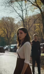 a couple standing on the side of a street