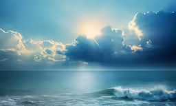 the sun shining through clouds above the ocean