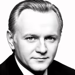 a black and white photo of a man with a tie on