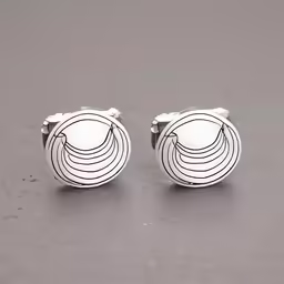 a pair of cufflinks with white and black pattern