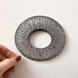 a wire scrunch sits on the white surface