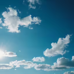a lone airplane flies beneath a bright blue sky