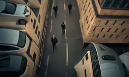 a street with cars and people walking around