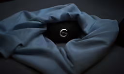 a ring is set in the middle of a dark cloth