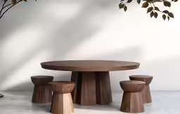 a round wooden table with four stools underneath it