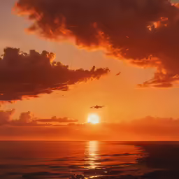 an airplane flying low over the ocean during sunset