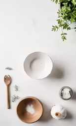 dishes from above, including a white soup and salad bowl and wooden spatula