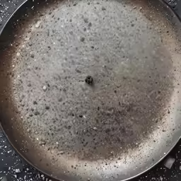 a frying pan filled with black and white batter