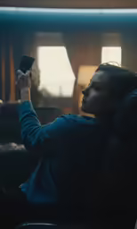 a person holding up a cell phone at home