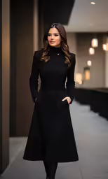 the woman is posing in a black dress and black heels